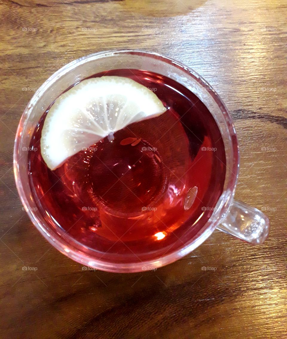 A cup of fruit tea with lemon