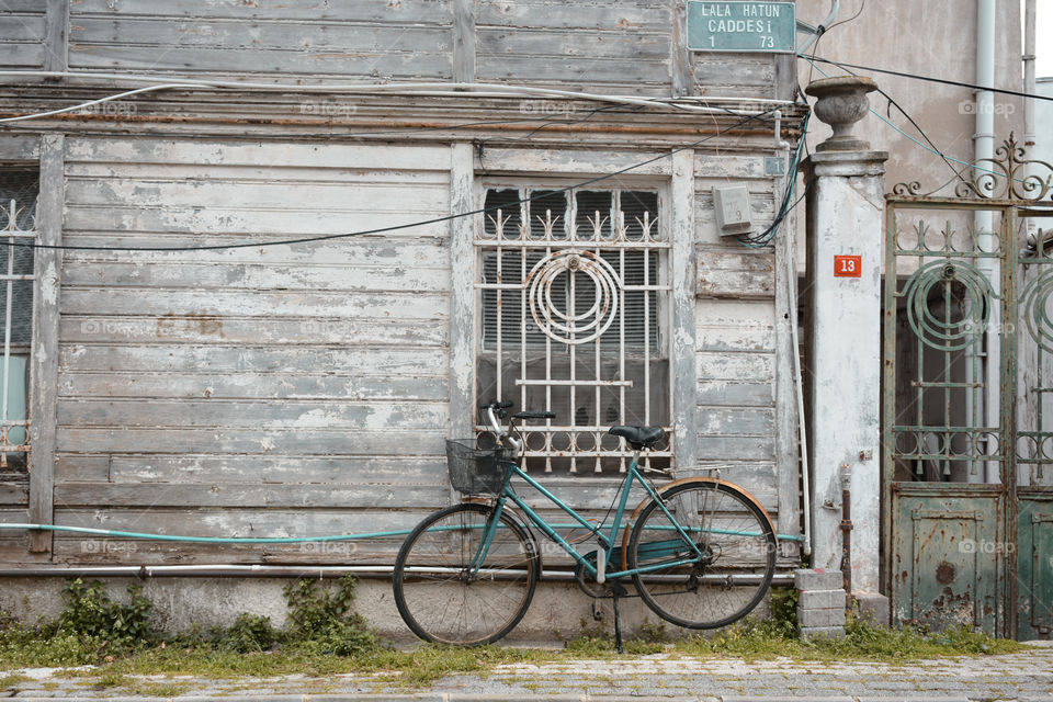 retro bicycle parked on an old wall