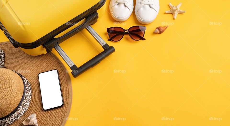 travel flat lay on yellow background