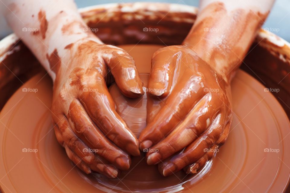 Close-up of person making pot