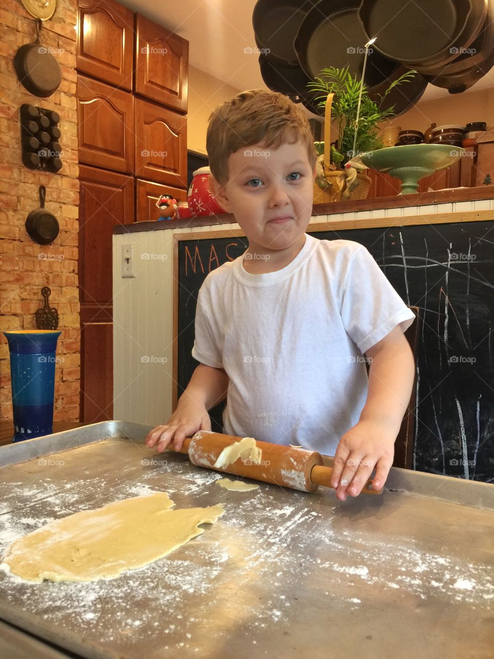 Boy preparing cookie in kitchen