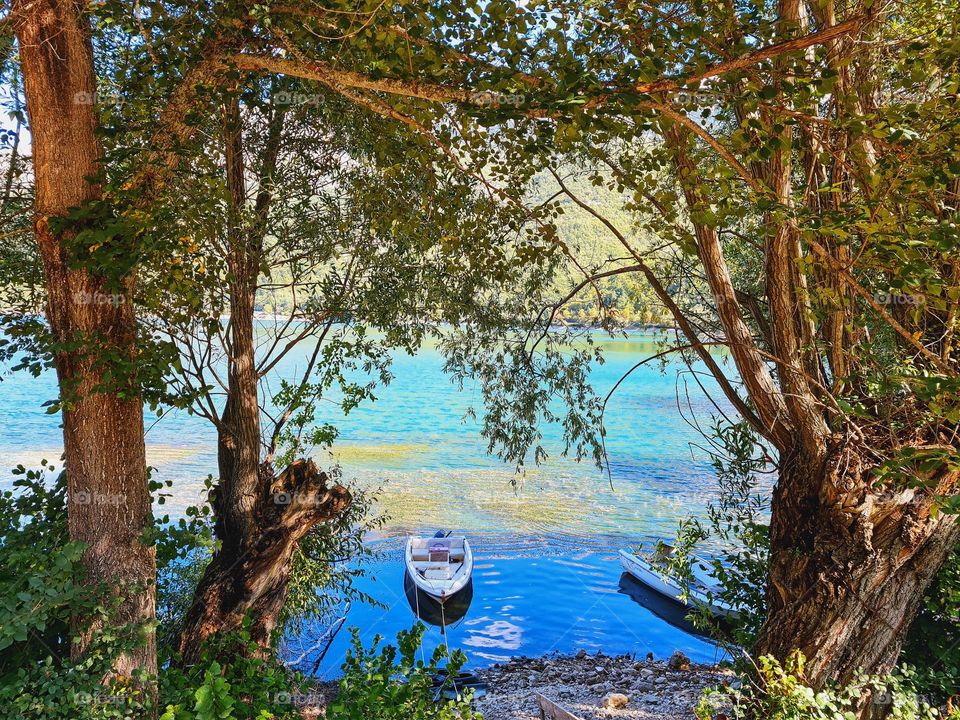 small boat on the shore of the lake stopped in a picturesque landscape