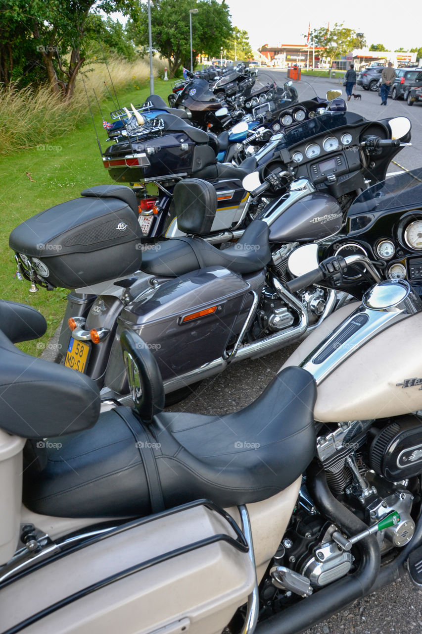 a large collection of motorcycles parked outside a hotel in Denmark.