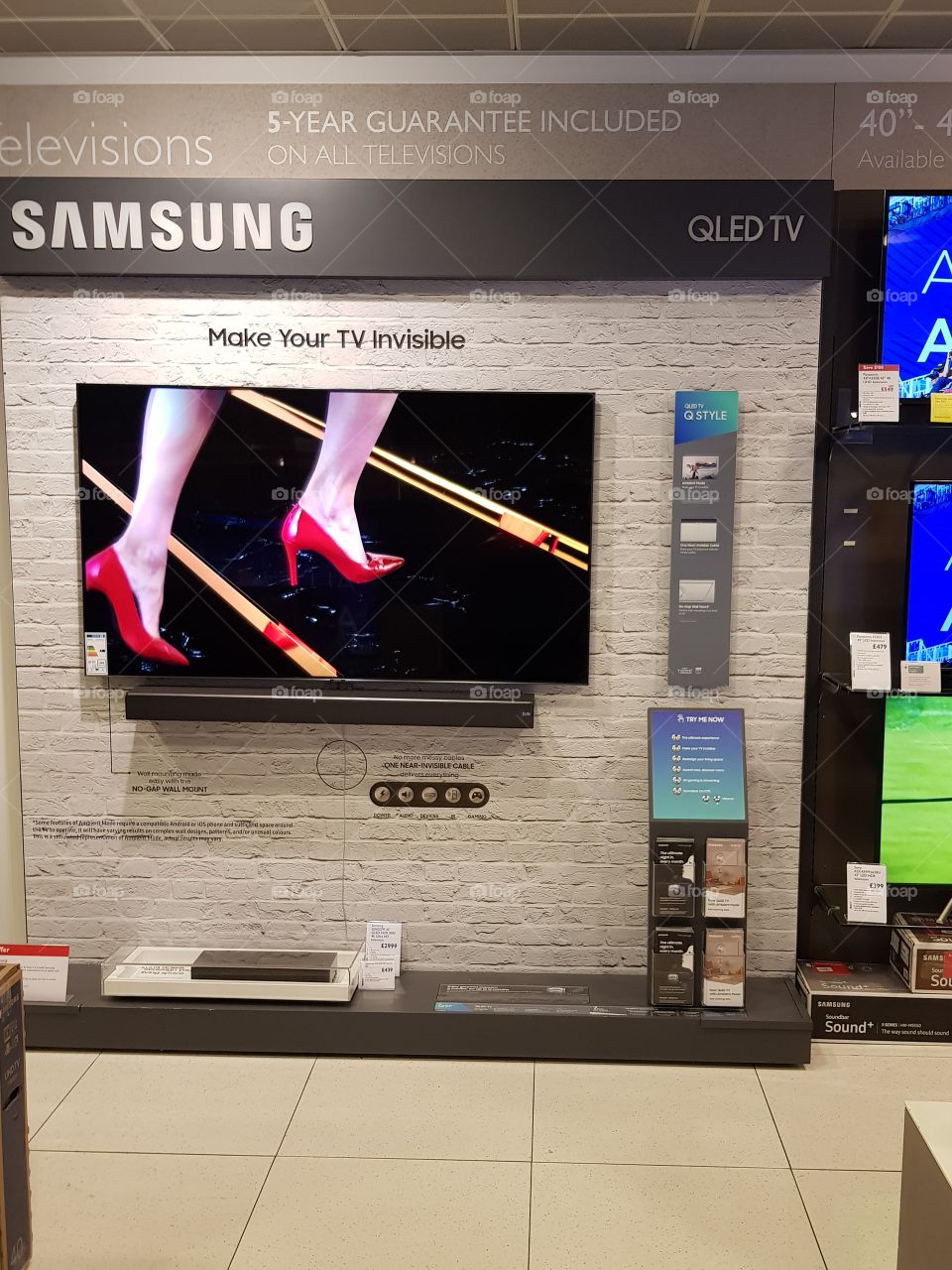 Samsung ambient mode 4K UHD TV QLED television with soundbar wall mounted display at Peter Jones Sloane square Chelsea King's road London