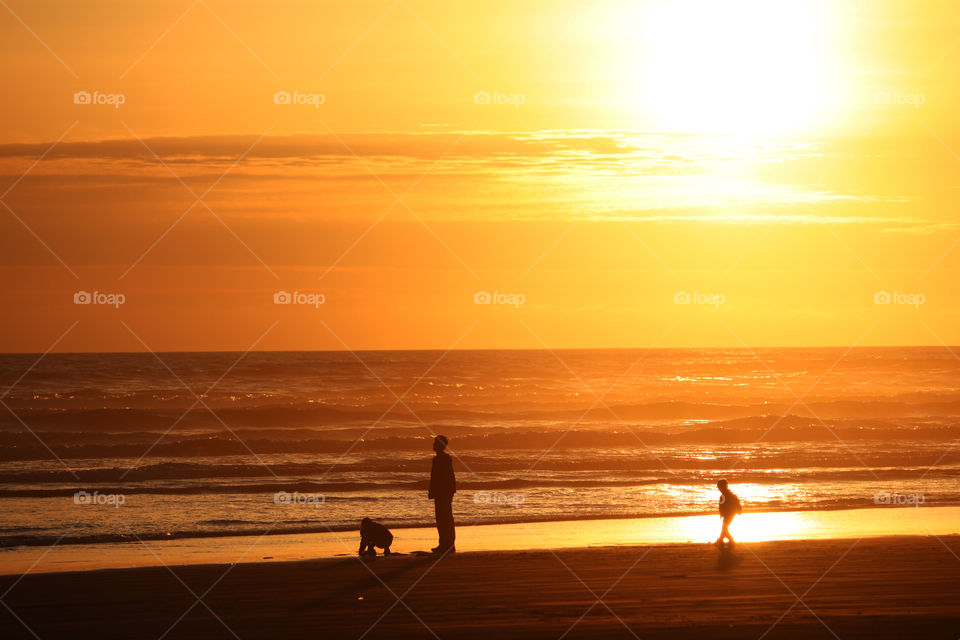 Family at Ocean Shores Beach at sunset