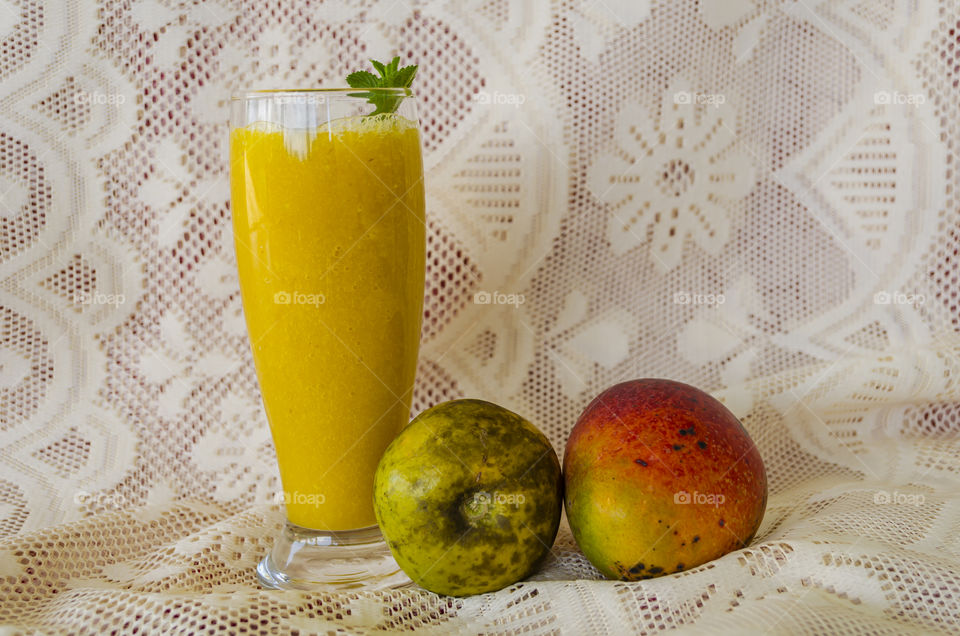 Whole Mango And White Sapote At Juice Glass Base