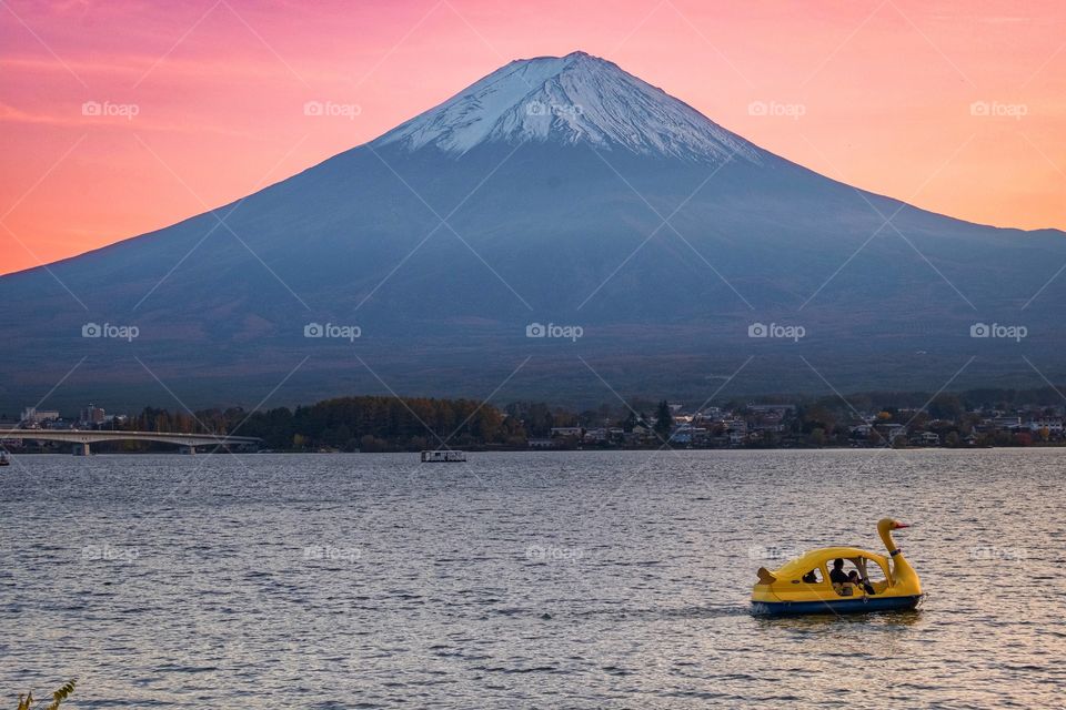 Strange view of Fuji mountain on pink sky background in twilight moment at Kawaguchiko lake , Japan