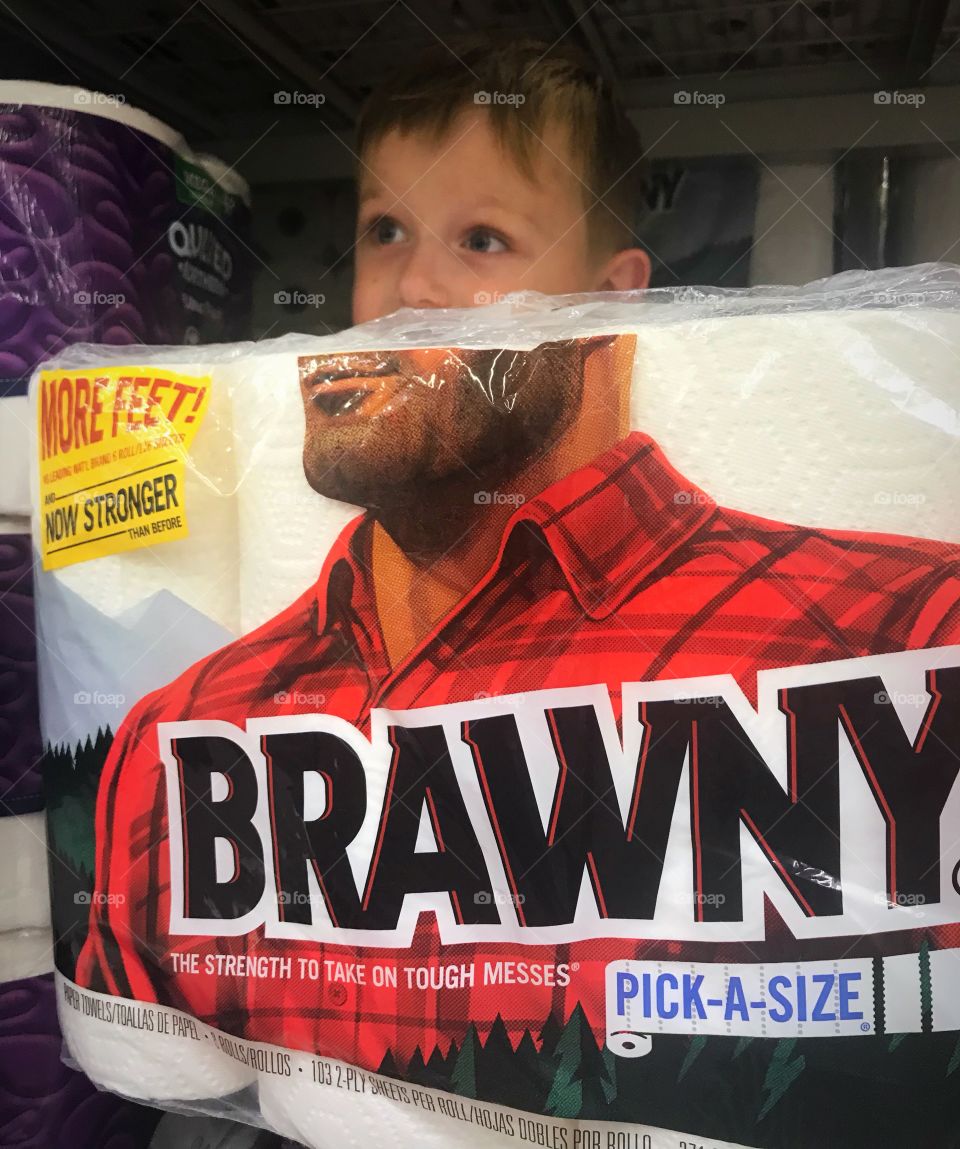 A cute little boy posing as the Brawny man while we were grocery shopping. 