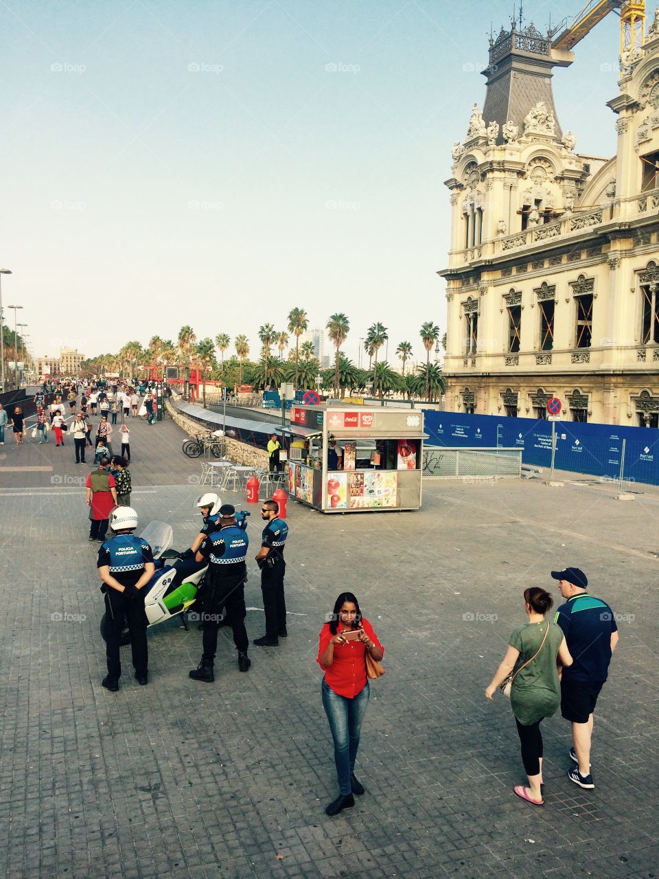 A busy street view with Spanish police on alert for danger in the city of Barcelona in Spain 