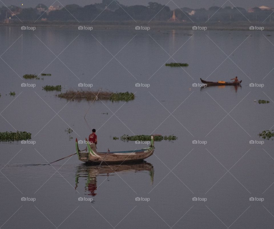 Myanmar guide tourists in boat to see local life at U bein bridge , the most longest wooden bridge in the world