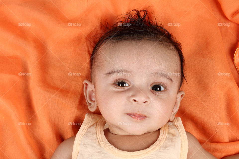 Cute Indian baby boy on Orange soft halftone