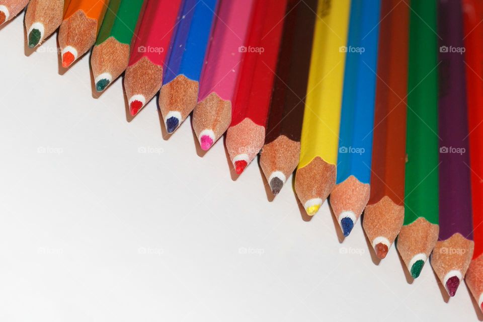 Multicoloured pencil in a row