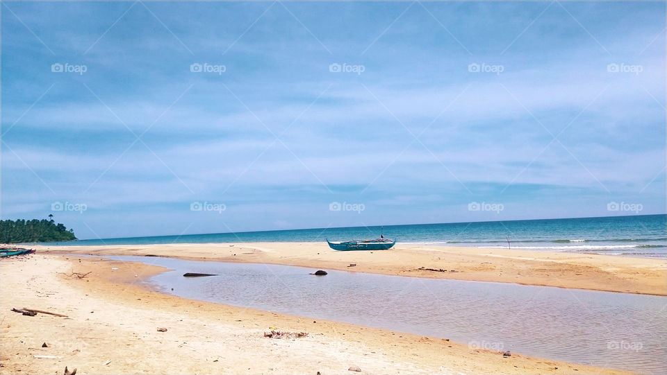 lovely view of a beach with a boat in the shore