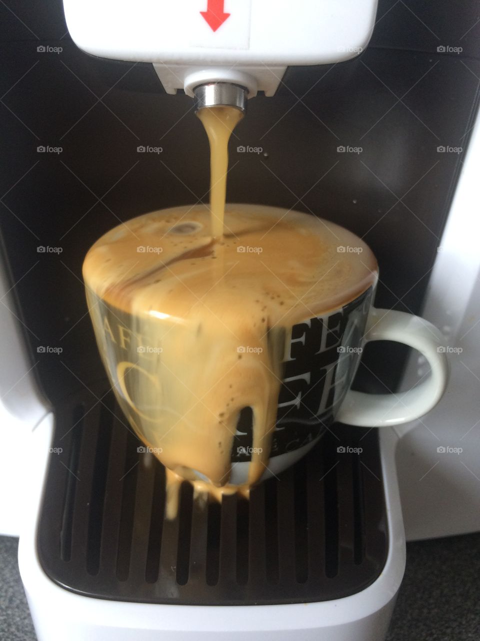 Overflowing espresso coffee cup
