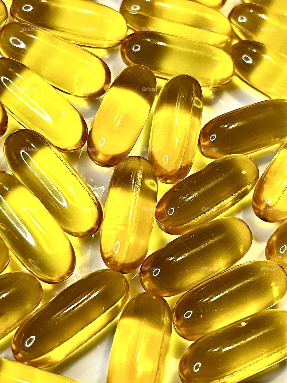 Transparent vitamin capsules shot close-up . Abstract . 