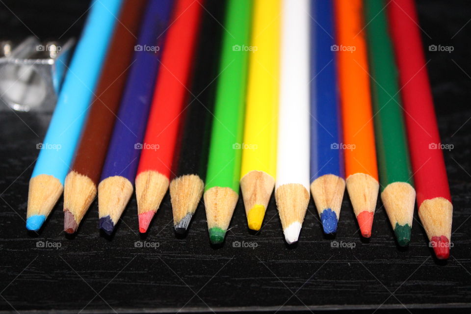 Coloured pencils against black background