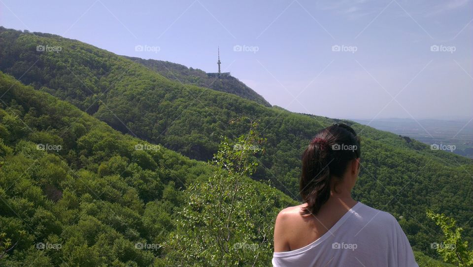 Rea view of a woman standing on mountain