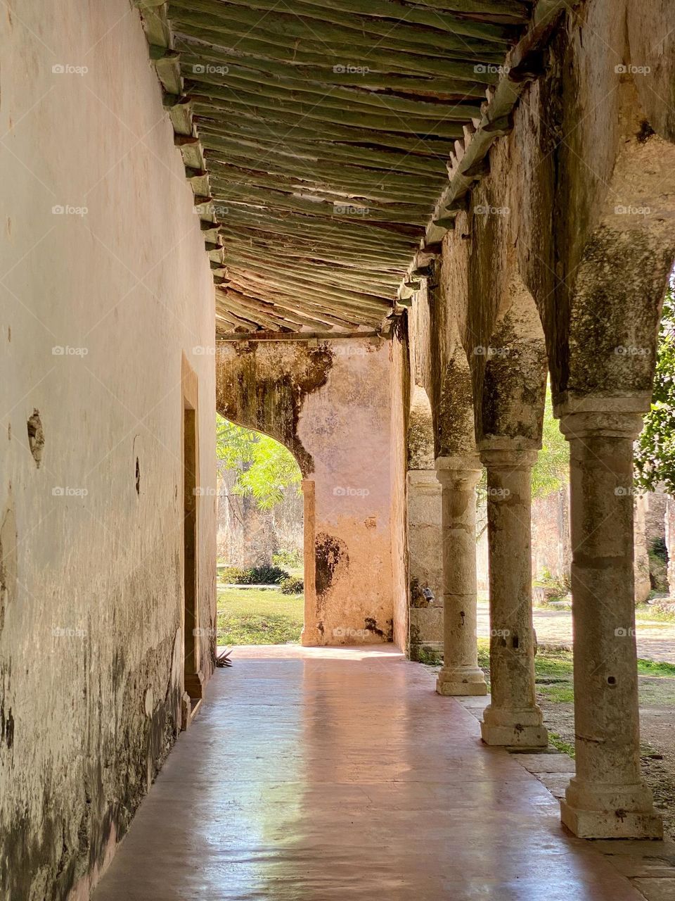 Looking down a row of columns outside of an old Spanish hacienda in Mexico 