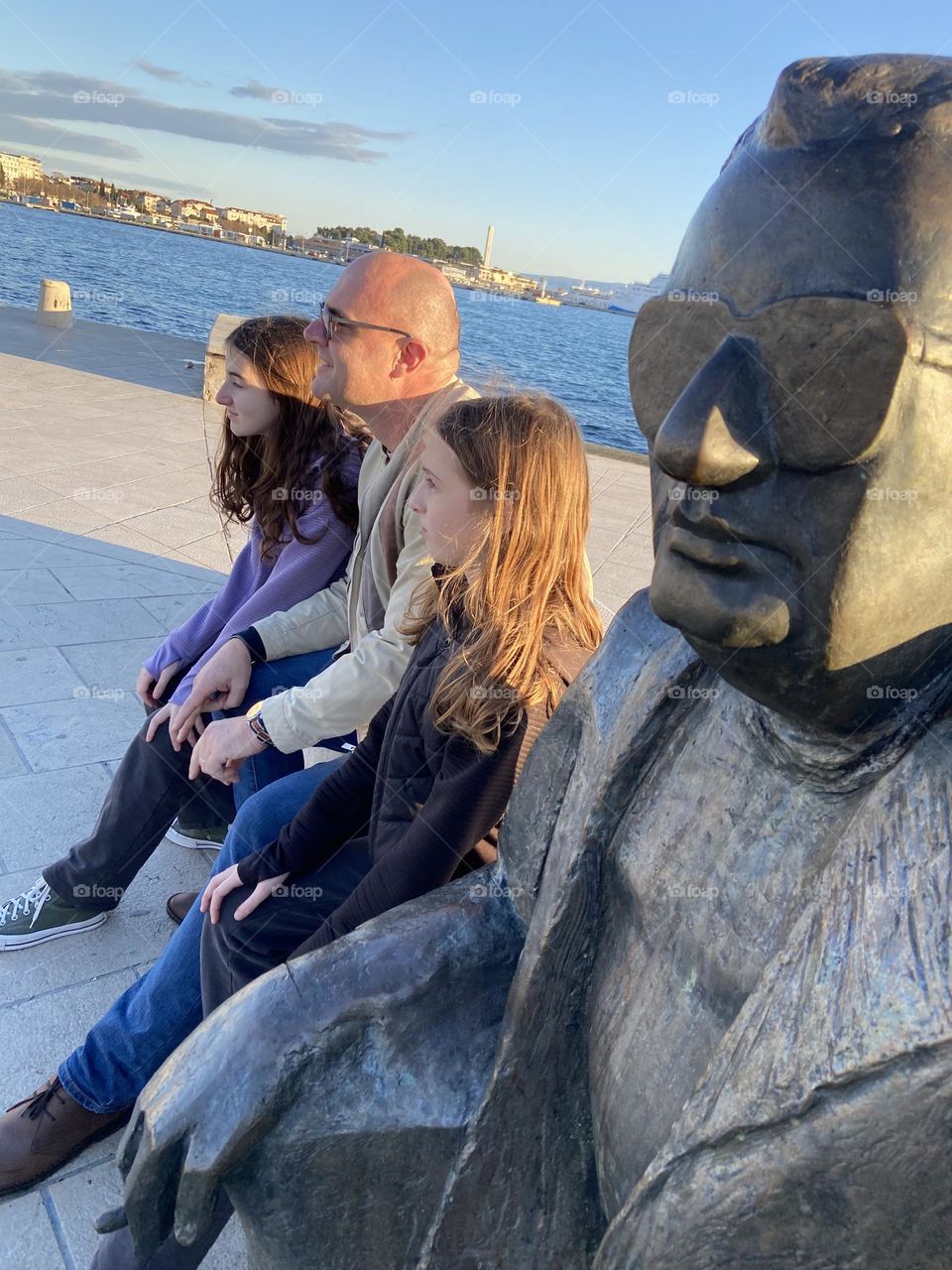 Relaxing by the Sea, Three humans and a statue sitting by the Adriatic Sea in Split, Croatia.