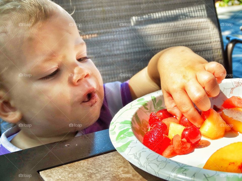 Toddler Grabbing A Treat
