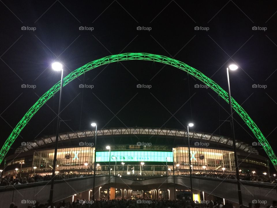 Wembley Stadium arch at night . Following the ed sheeran concert July 2015 the arch was lit up green. 