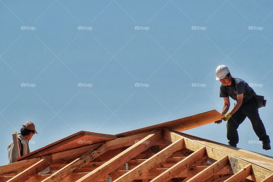 Carpenters Installing A Roof
