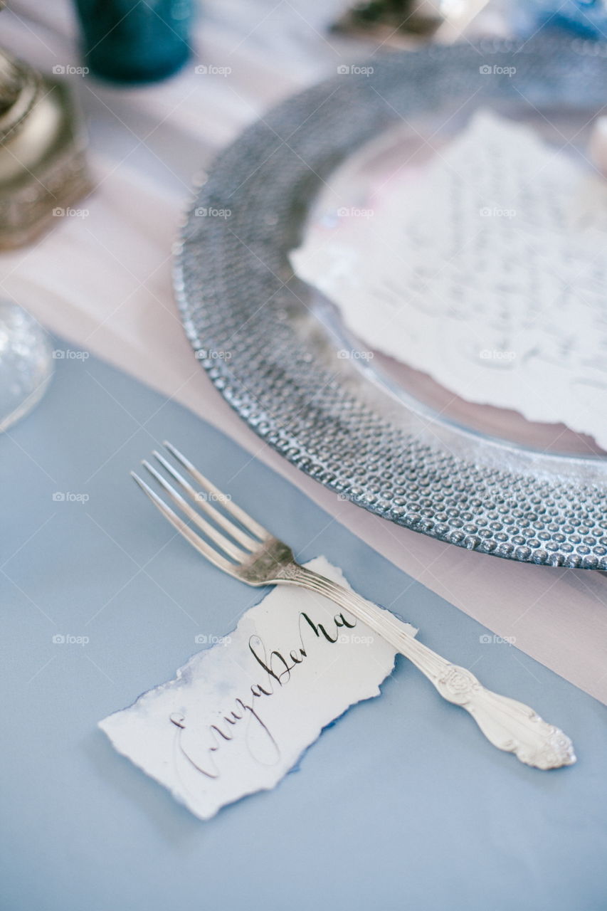 Silver fork as element of table wedding centerpieces decorations