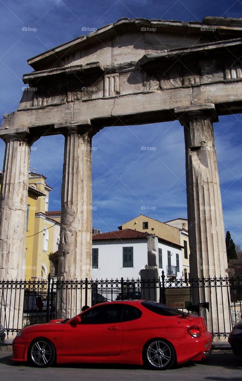 Athens, Greece: Ancient and Modern, red sports car parked in front of ruins 