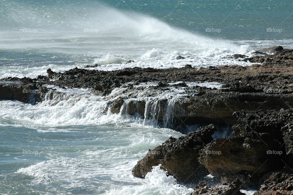 Wave splashing rock