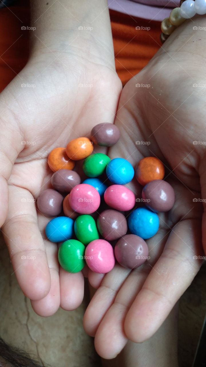 Colorful candy in the palm of the hand