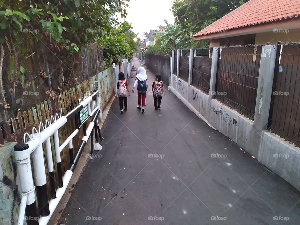 Elementary students go to school in early morning