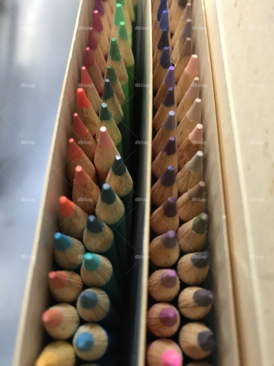 Box of colored pencils in many colors