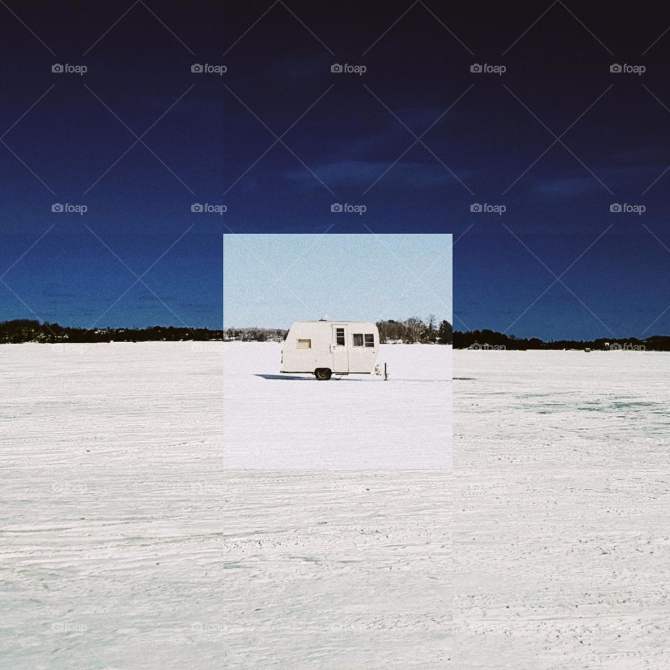 fishing trailer in the middle of frozen Canadian lake in winter