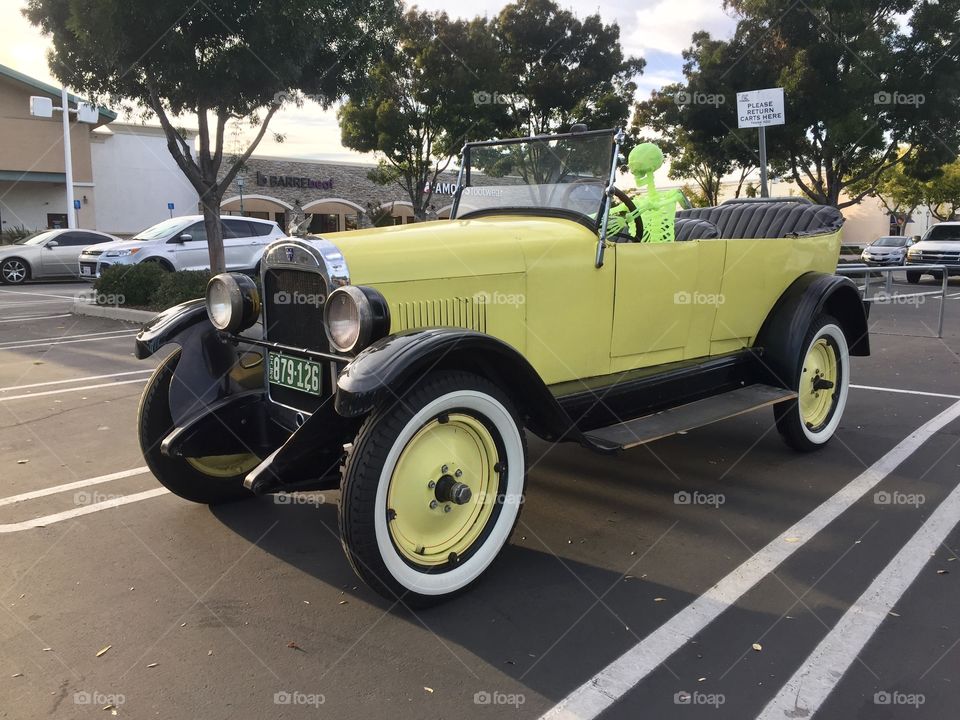 Old car with a green skeleton 