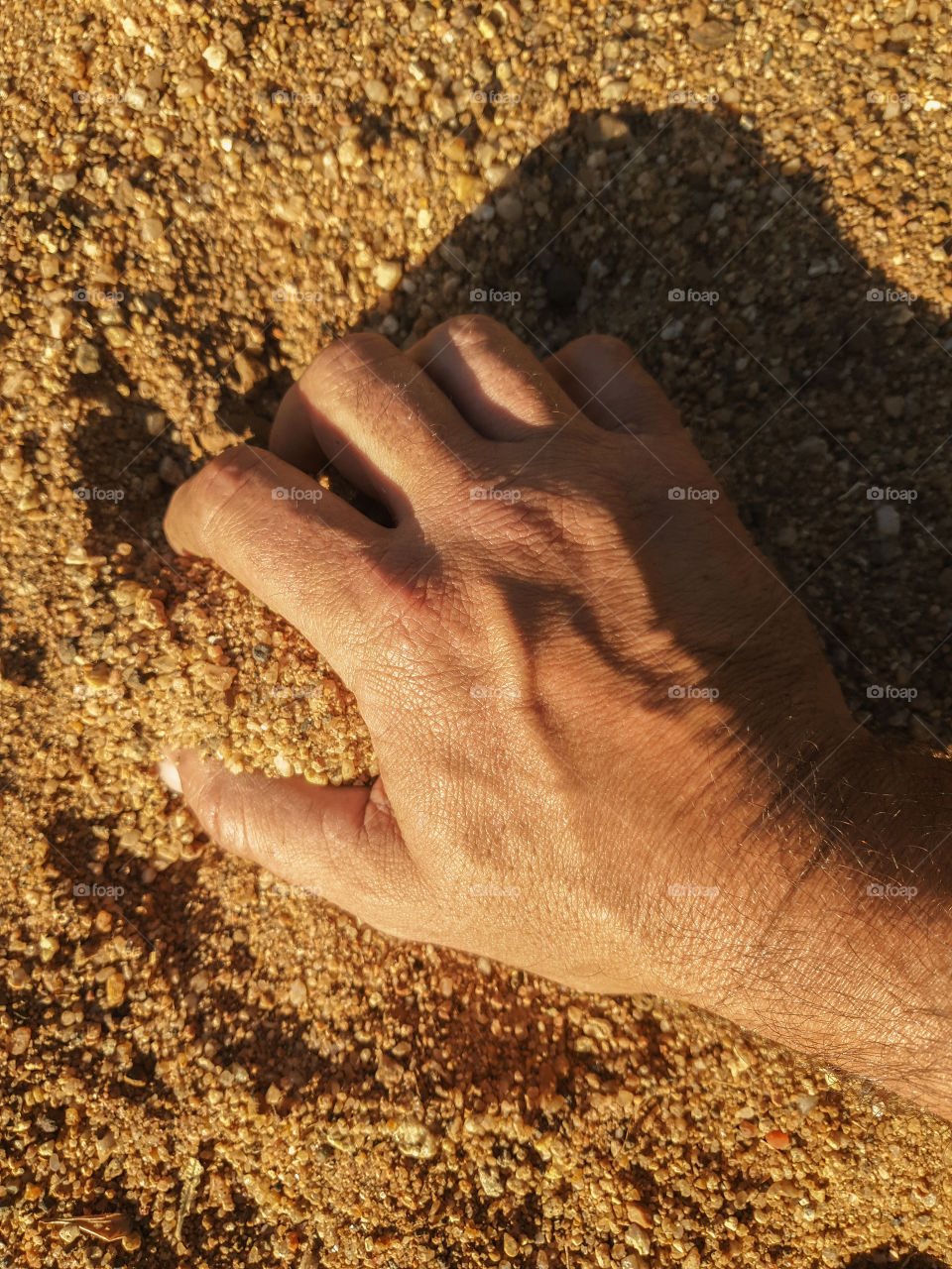 hand grabbing sand