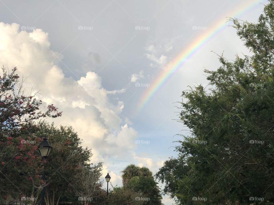 Rainbow and puffy clouds after a storm