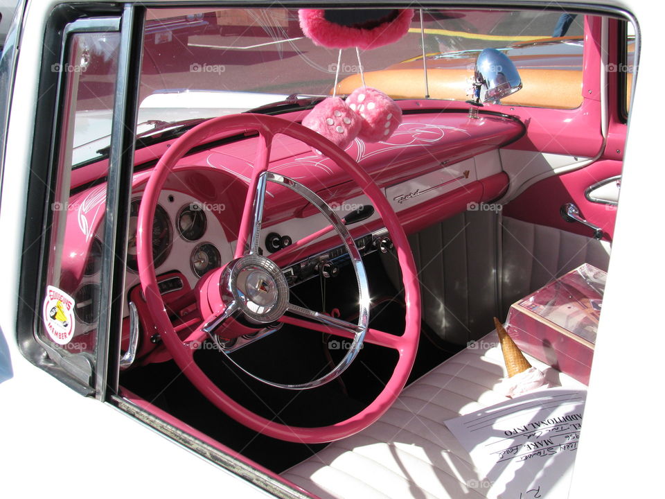 inside of a classic pink Ford. taken at an auto show