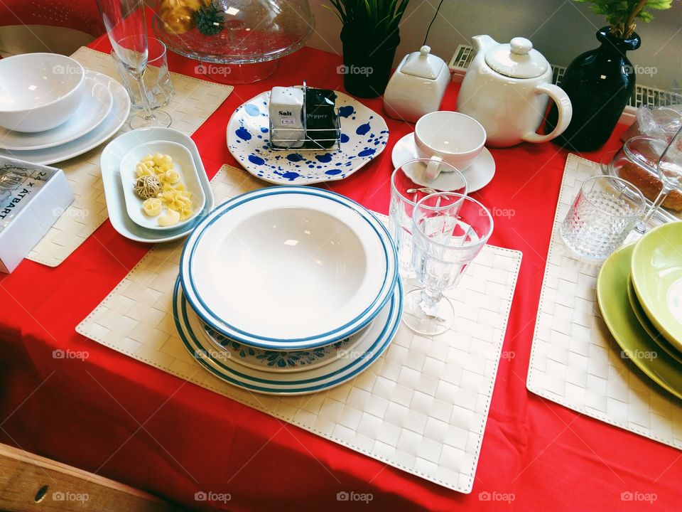 Glasses, cups, plates, kitchen accessories lie on the kitchen table