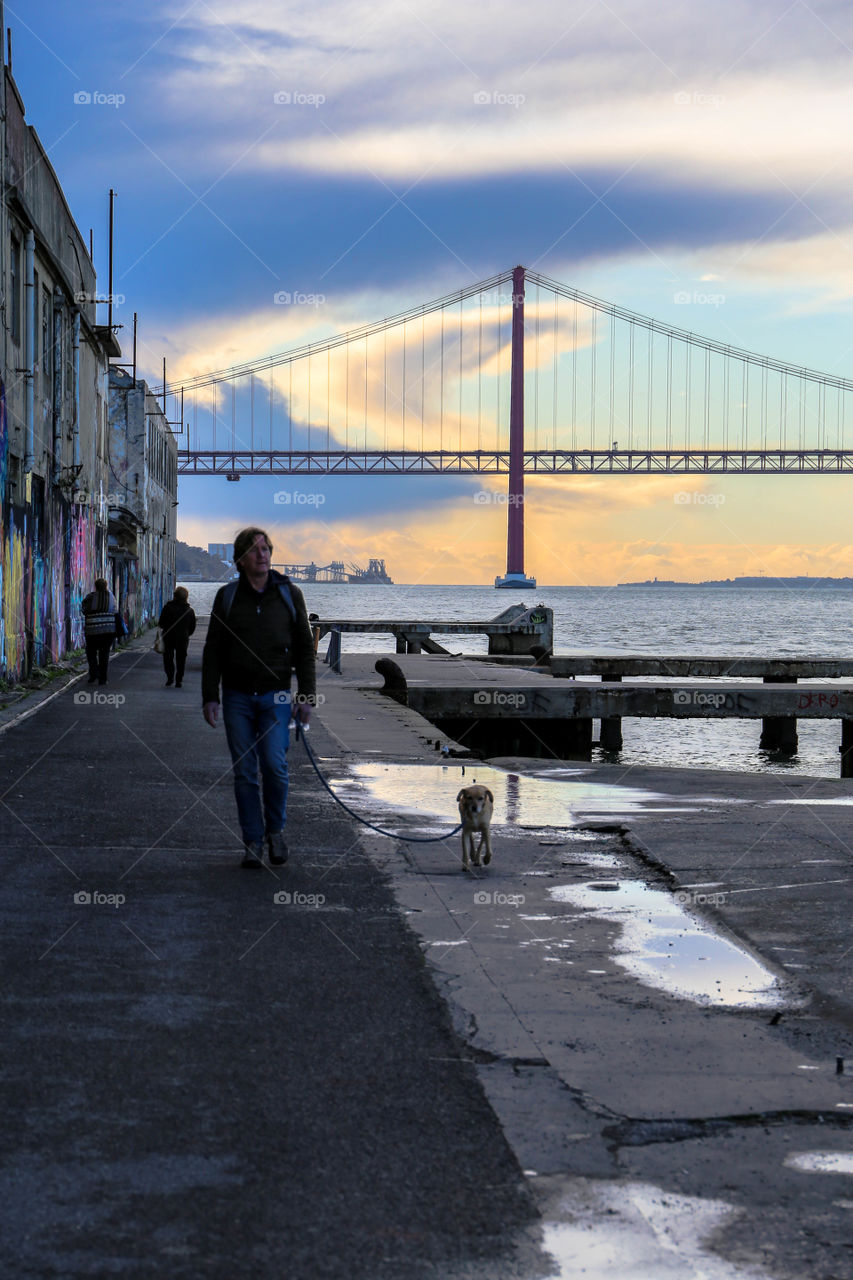 walking his best friend on an abadoned harbor