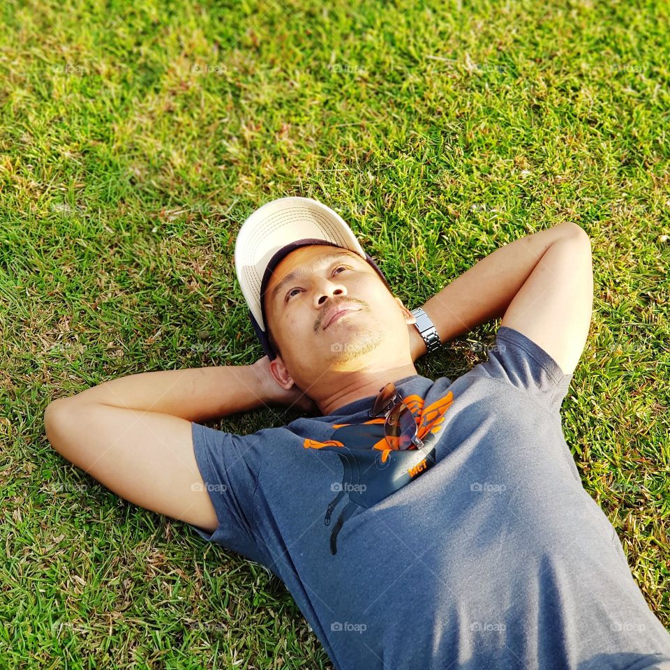 Man lying dow on grass