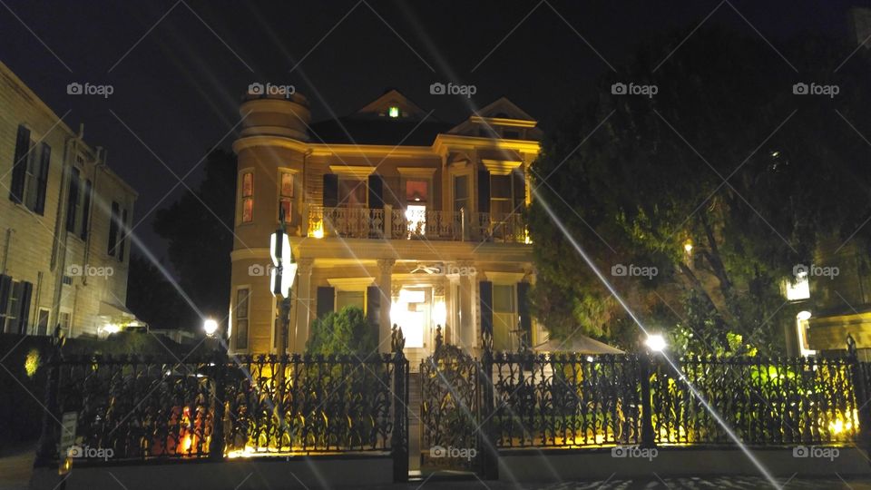 Victorian architecture at night. Gated/fenced home in New Orleans, LA.
