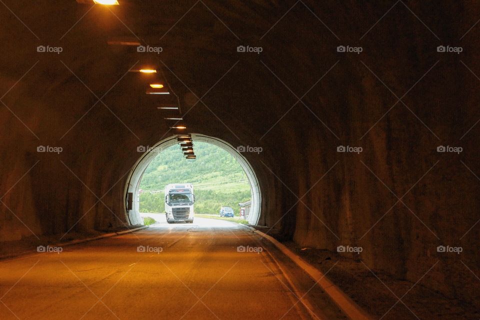 A truck drivning throu a tunnel