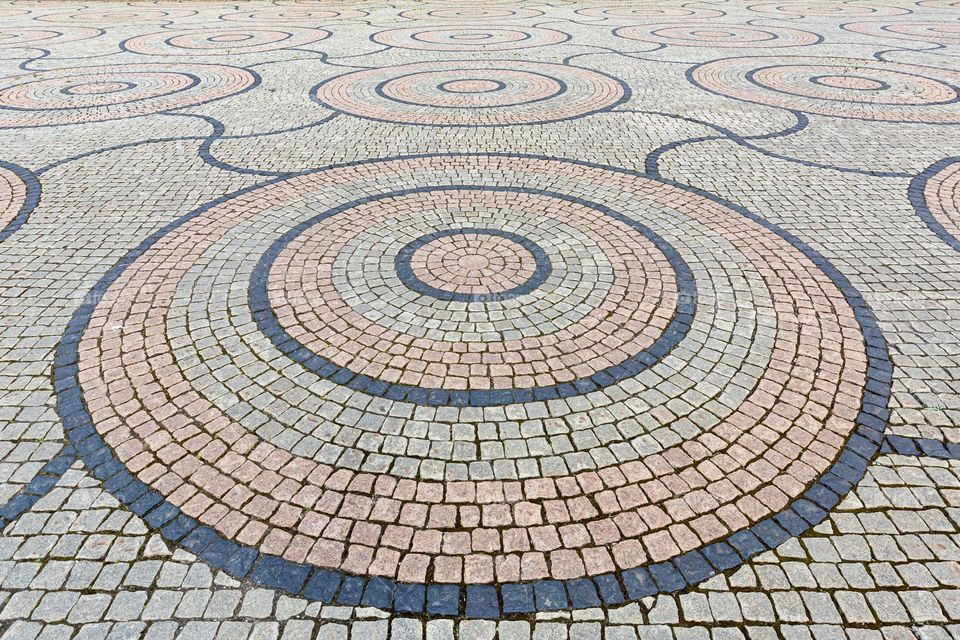 Round circle pattern made by paving stones in different colors 