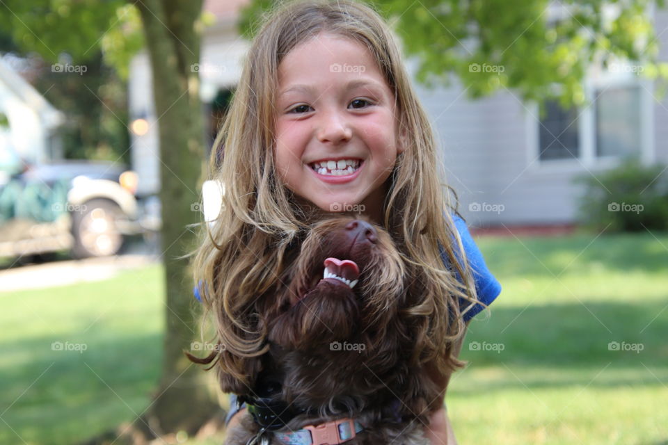 Smiling girl with her happy dog