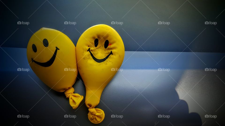 Yellow smiley face balloons.