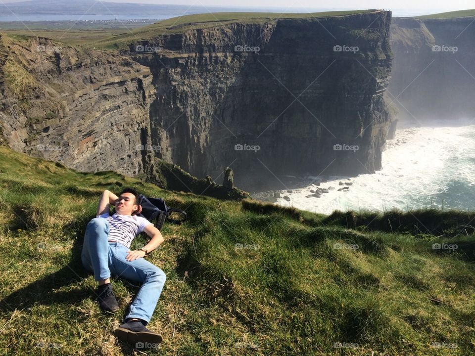 Enjoying spring at the Cliffs of Moher! . Expectation: bask in the sun and listen to the waves crashing onto the rocks.  Reality: try not to fall off a cliff for a picture 😂