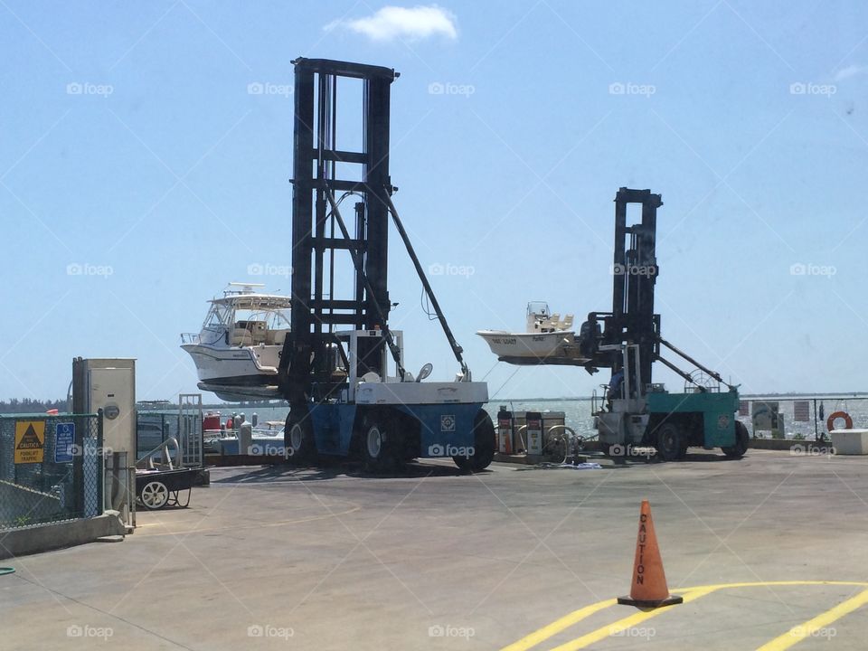 Boats being lifted from the water in to dry storage at a marina in Florida 