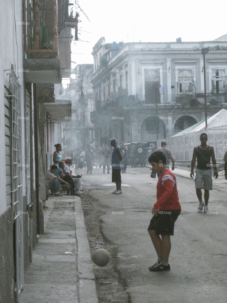 Kid playing football on the street
