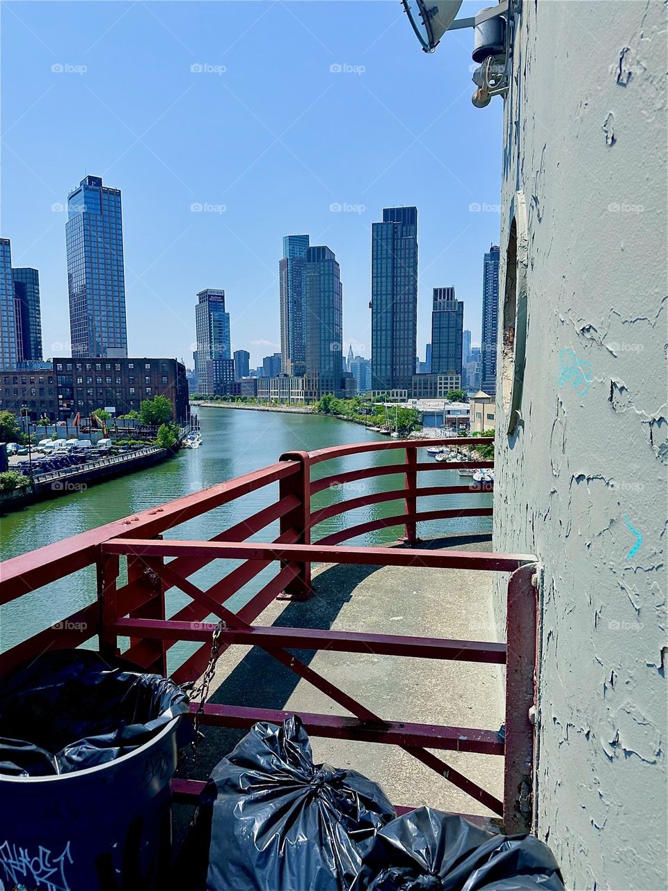 This is the watchtower of the “Pulaski Bridge” at “Newtown Creek” that connects “Greenpoint”, Bklyn to LIC, Queens. Across the shimmering waters of the “East River” we see “Greenpoint” on the left, “Manhattan” on the right. 2024. Hypnotic Productions