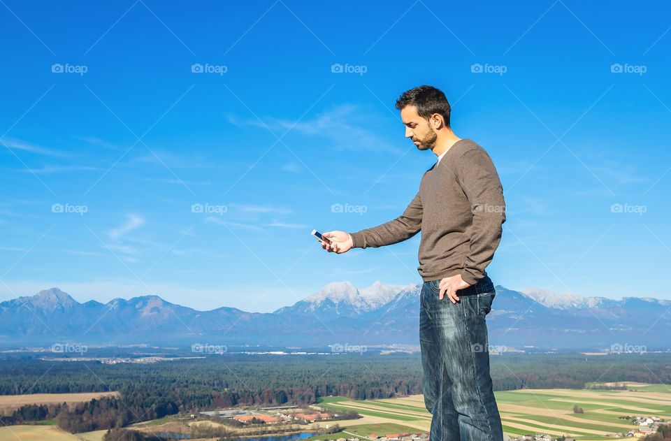 Young man using smartphone on holidays 